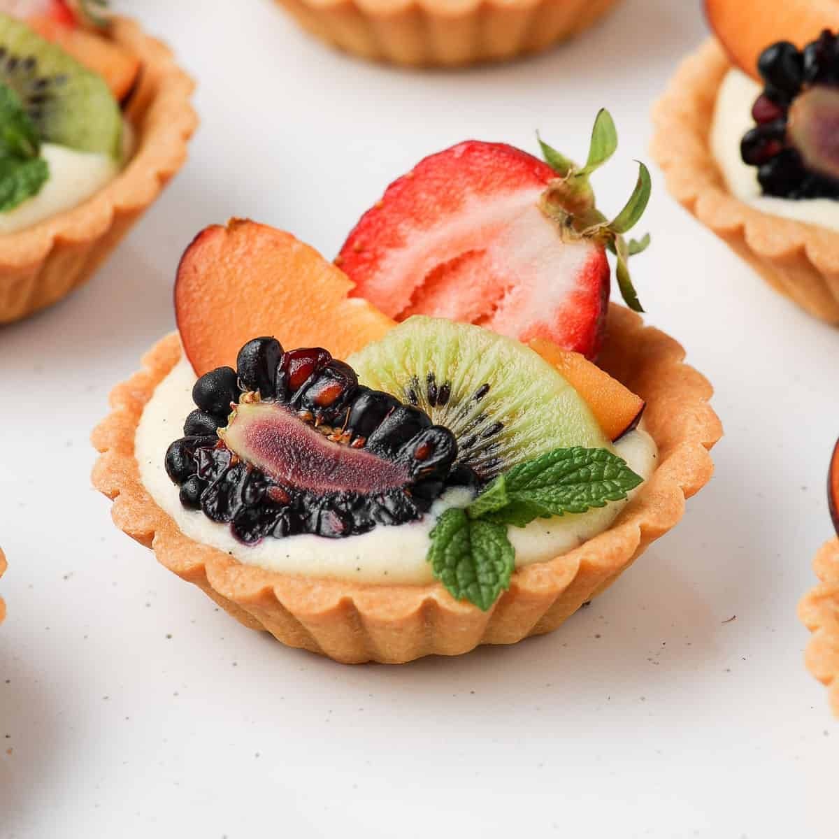 Fruit Tart — seasonal fresh fruits on pastry cream in a buttery shell
