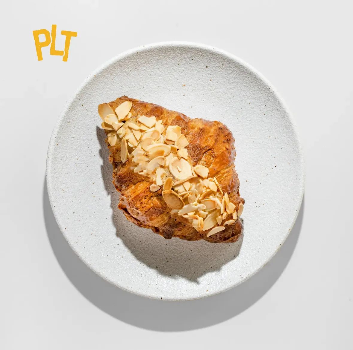 Almond Croissant — frangipane filled, crowned with toasted sliced almonds