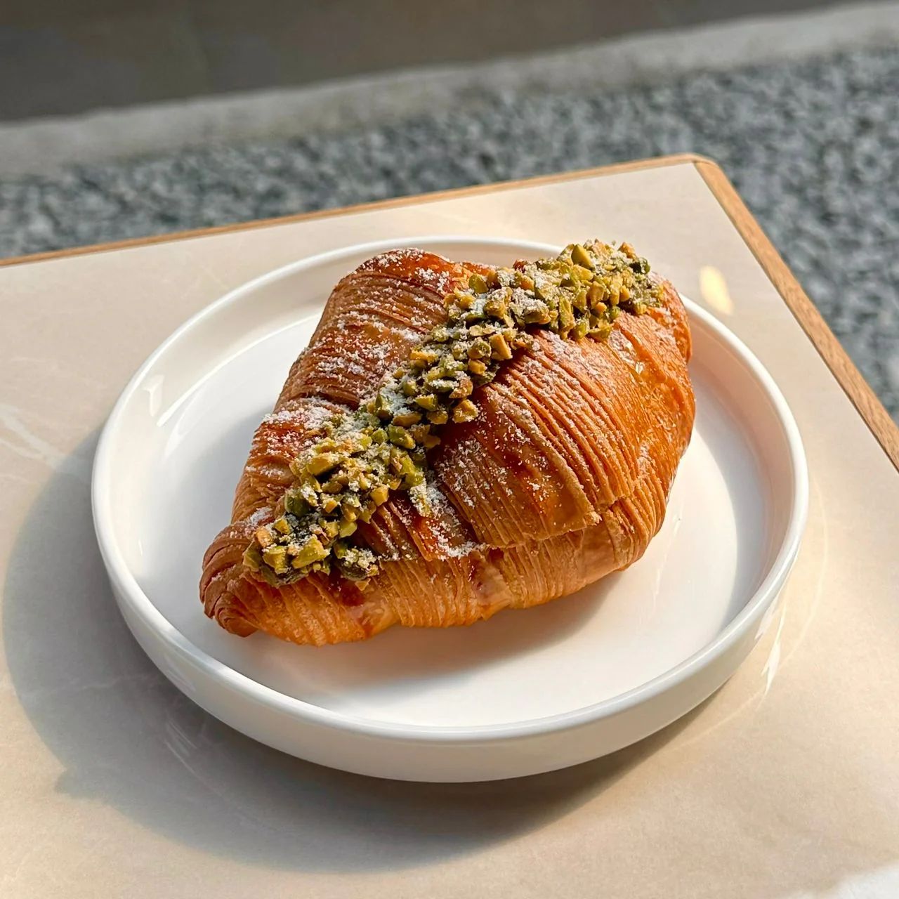 Pistachio Croissant — green pistachio frangipane, crushed pistachios topping